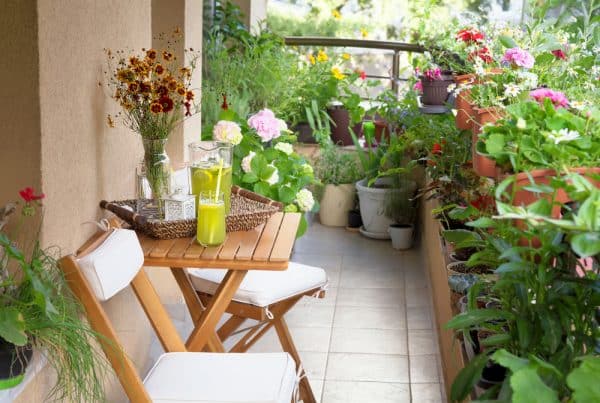 Beautiful,Terrace,Or,Balcony,With,Small,Table,,Chair,And,Flowers.