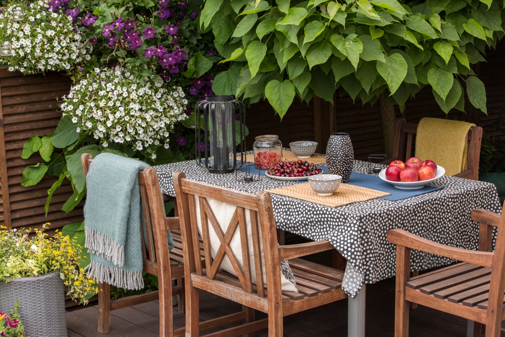 Garden,Table,Full,Of,Fruit,,Wooden,Chairs,On,A,Terrace